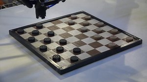 clip-1012126913-robots-play-match-checkers