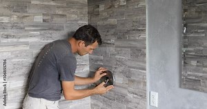 Plumber fixing shower. Workman repairing shower in bathroom.