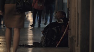 Download Man beggar sitting in busy street