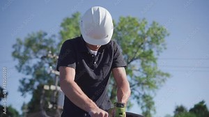 Roofing Inspector performing a core test on a flat roof on a sunny day