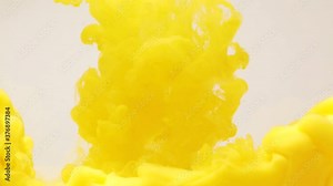 Abstract background of splashes of yellow paint in water, an explosion of yellow color, splashes and spreading of bright colors Stock Video