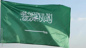 Saudi Arabia National Day. Flag of Saudi Arabia waving against the wind in beautiful clouds sky, outdoors backgrounds, slow motion. Concept National Day, Independence Day, Patriot, celebration, Riyadh