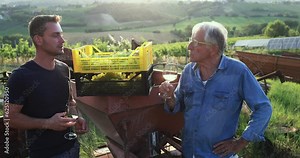Wine producer multi generational men tasting the product after harvest and grape fermentation process - Vinification, organic quality product and small business concept