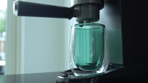 clip-4031243125-espresso-machine-bright-kitchen-pours-coffee-into