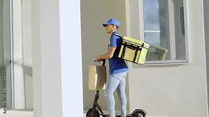 African delivery man ringing doorbell holding paper bag