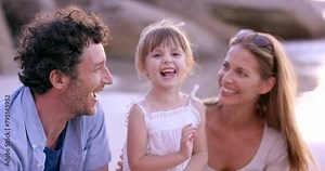 Happy family, kid and parents tickle at beach on vacation, summer holiday and travel outdoor. Funny mother, father and girl at ocean having fun, child laugh and bonding together at sea while playing Stock Video
