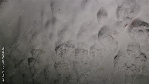 Close-up of natural salt formations inside a salt cave, showing mineral textures and crystalline surfaces. Geological detail of underground environment and natural deposits.