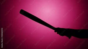 Man holding baseball bat close-up, shadow silhouette of hand with weapon on pink neon background, sport equipment.