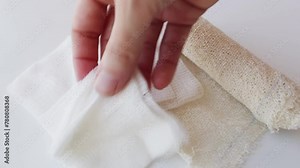 Medical hospital bandages and an empty syringe being handled by human hand