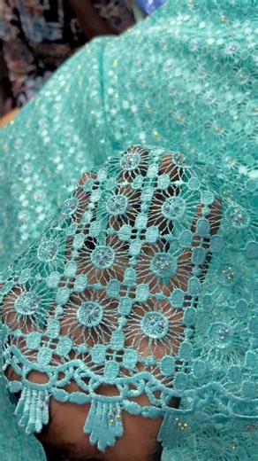 Close-Up View of Intricate Turquoise Lace Fabric