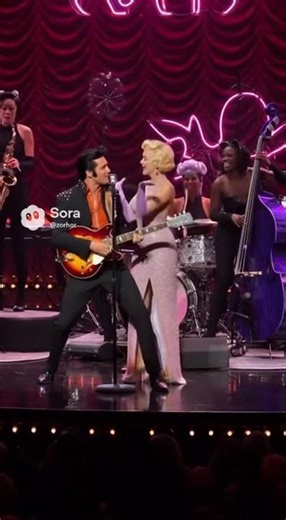 Elvis Presley & Marylin Monroe singing on stage with the CatWomen band