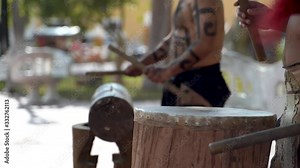 Extreme closeup of Mayan or Aztec drummers playing wooden drums with animals skins and sticks in a park in Valladolid, Mexico. Stock Video