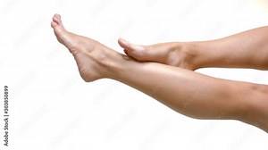 Close up on smoth woman legs with healthy skin over white background.