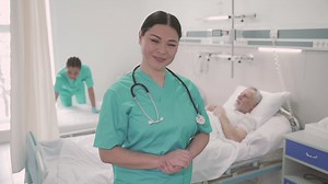 Woman nurse looks directly into the camera and smiles Free Stock Video Footage
