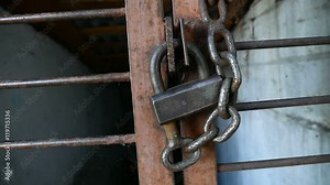 Old iron lock on the iron video bars prison