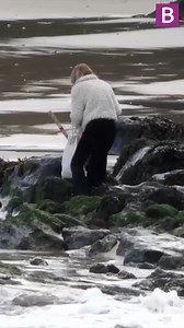 Yule-tide Christmas shopper gets a soggy surprise after taking shortcut over beach with bags of festive shopping'. It happened at Towan beach, Newquay, Cornwall. Luckily despite getting wet feet and legs she managed to reach safety. | Birmingham Live