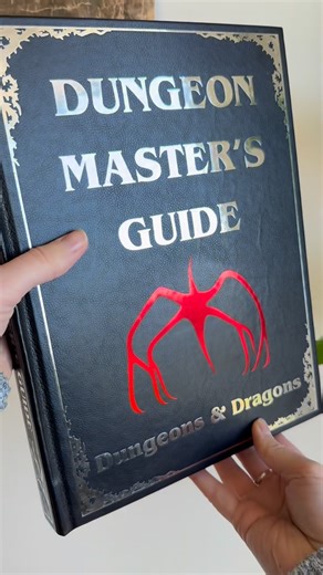 Em on Instagram: "Gave this Dungeon Master’s Guide a Stranger Things facelift in honor of Season 5 part 1 ❤️‍🔥 Had to make sure the classic DnD villains from the show, Vecna and the Mind Flayer, were prominently showcased in this special edition! Can’t wait to keep watching, this was such a fun bookbind to do right after finishing part 1 🖤 #strangerthings #dungeonsanddragons #bookbinding stranger things rebind, dungeon masters guide, stranger things season 5, dnd rebind, custom bookbinding, ha