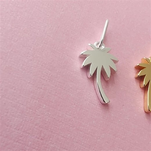 Bring paradise wherever you go with our Palm Tree Charm. Standing at 14mm, this piece is available in 18K gold vermeil. Add a touch of tropical vibes to your everyday style. The elongated connector easily fits over most chains, allowing for easy customization. Please note that the charm is sold separately without a chain. Add it to your favorite chain or choose from our selection of chains and NEW 2mm size gemstone beaded necklaces. Packaged in our signature glass bottle.