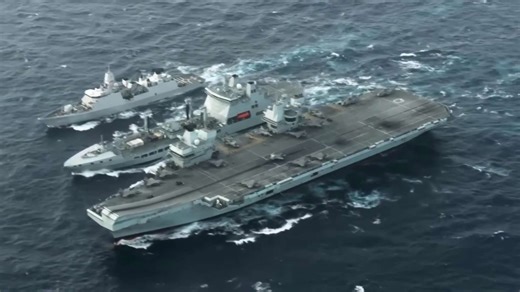 Surface combatant tracks British carrier through Pacific operational deployment