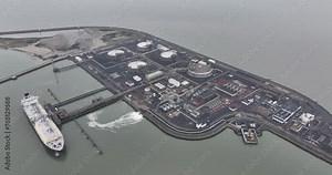 Liquid natural gas terminal, transportation over sea. Storage distribution and shipping. Energy industry, fossil fuels. LNG tanker docked at LNG terminal. Import and export at Zeebrugge, Belgium