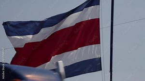 Costa Rica flag gently waving in slow motion in the wind, with vibrant red white and blue colors outdoors