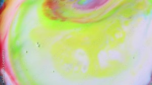 Drops of colorful paint mixing in milk. Chemistry experiment for children, swirl and explosion of colors
