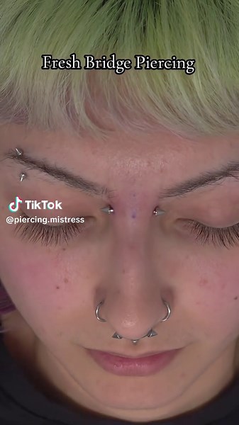 Fresh bridge piercing on my client Valerie! The bridge suits her so well and doesn't interfere with where her glasses sit. DM me if you have any questions. Link in the bio for appointments and availability. . . . #bridgepiercing #facialpiercings #piercingsnearme