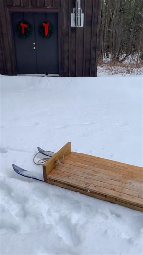 Homemade sled made of furring strip and skis