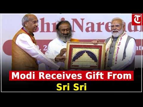 PM Modi Receives Special Gift From Sri Sri Ravi Shankar At Art Of Living Event Bengaluru