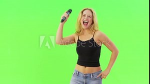 Woman singing karaoke with microphone