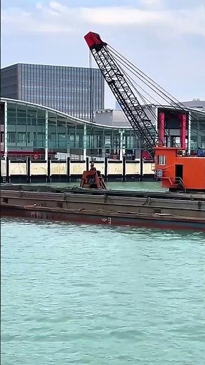 Clamshell Dredger Working on Canal Dredging