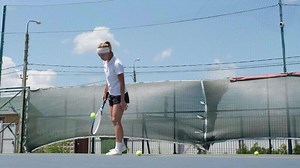 woman playing tennis on tennis court