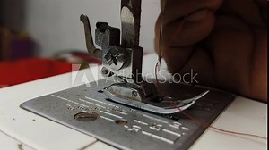 Tailor hand lowering professional clothing accessory electric sewing machine stitching hem tool and needle without fabric. Tailoring or textile industry machinery concept. Closeup macro side view.