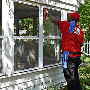 Safely clean ash from windows with steel wool, a sponge, soap and squeegee