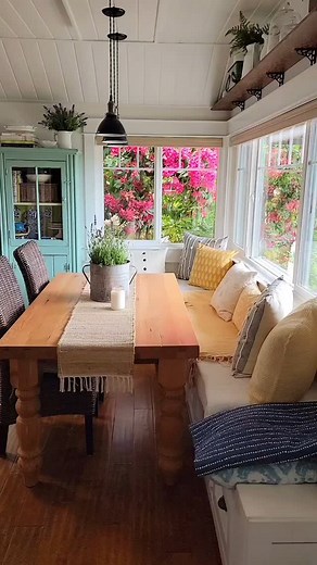 Think cottagecore meets coastal summer style. Soft blues, sunny yellow accents, and vintage favorites fill our little kitchen this time of year. Simple touches like a lavender plant and an old galvanized bucket, the cozy window seat filled with pillows and throws, and my favorite vintage turquoise cabinet. Even the old pots and pans feel a little extra charming in the summer light. It's simple, cozy, and full of that laid-back cottage style I love. #coastalcottagestyle #vintagekitchendecor #cott