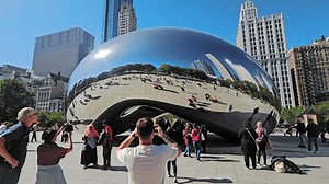 Chicago Illinois 10 December 2024 Cloud Gate and many tourists on a sunny day, The iconic Cloud Gate sculpture in Chicago, reflective design and urban architecture