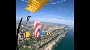 U.S. Army Paratroopers Fly the American Flag Over Chicago