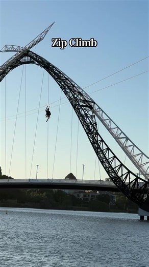 Experience the thrill of the Matagarup Bridge Zipline in Perth, soaring 72 meters above the Swan River. Launch from the bridge's iconic arch and fly 400 meters at speeds up to 75 km/h for an unforgettable, high-speed descent towards Optus Stadium. #perth #river #bridge #climb #zip