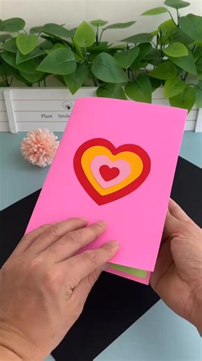 Step-by-Step Pop-Up Peacock Card 🦚✨💌 Steps: • Take a sheet of cardstock and fold it in half to make the card base. • Cut out a peacock body shape from blue or green paper. • Cut several feather shapes in different sizes and colors. • Fold each feather slightly in half to give a 3D look. • Arrange the feathers in a fan shape and glue their bases together. • Attach the peacock body in front of the feather fan. • Glue the whole peacock onto the inside fold of the card so it pops up when opened. •