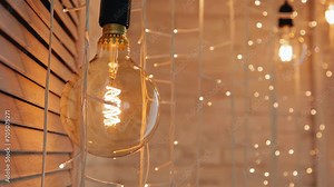 A close-up of a large lamp that decorates the room and illuminates it with warm light. Very beautiful color