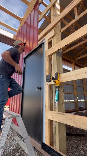 Cutting out & installing a sheet of wall metal around a cannonball door! Notched for positive water flow & caulked for peace of mind 💯 #CinchCarpentry #QualityOverQuantity #PostFrame #Metal #Cladding #Installation #Door #ExteriorFinishes #Barn #Stables #Equestrian #Alberta | Cinch Carpentry