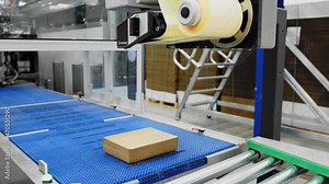 Closer look at automated packaging equipment; labels put on boxes