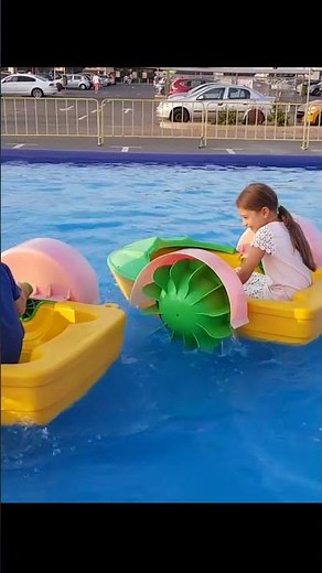 Children play with boats on the water