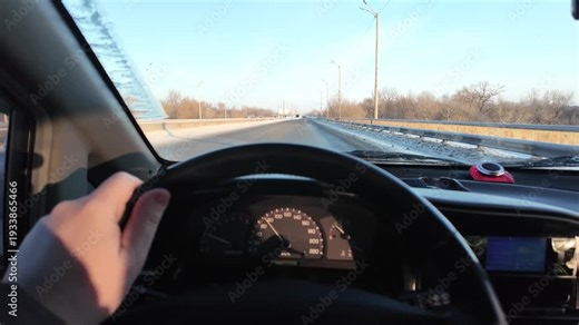 Driver driving a car. First-person view. POV. Slow motion video. Person driving a car. Traveling. Bad road.