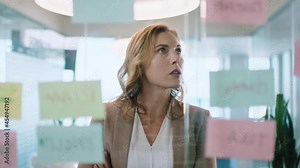 beautiful business woman using sticky notes brainstorming ideas planning strategy problem solving with creative mind map working on solution in office 4k