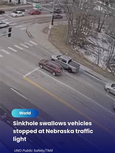 26 Feb 2026: Two vehicles were partially swallowed by a sinkhole that suddenly opened at a Nebraska intersection on Tuesday (Feb 24). Both drivers were able to escape unharmed, with bystanders assisting them before emergency crews arrived. The Omaha Police Department has closed the street in both directions, warning that the sinkhole could expand. @thesundaily #theSun #theSunMY #Nebraska #Omaha #UnitedStates