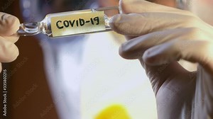 Laboratory scientist analyse test tubes with blue liquid. Searching for cure from Covid-19. Medical experiments. Virus vaccine testing