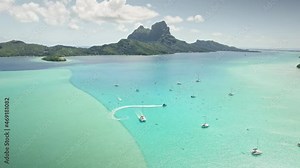 Bora Bora drone aerial view, clear water lagoon beach. Tahiti island. French Polynesia. Exotic travel vacation getaway, romantic honeymoon destination.