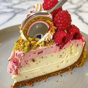 Creamy, zesty, and stunning! This lemon raspberry cheesecake topped with pistachio crumb is pure elegance—perfect for any celebration or cozy dessert night. 🌿 #CheesecakeRecipe #LemonDessert #BakingInspiration | Taylor Davis