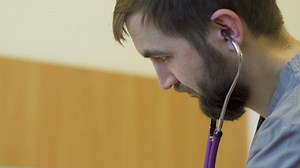 Young doctor listening through his stethoscope - Free Stock Video